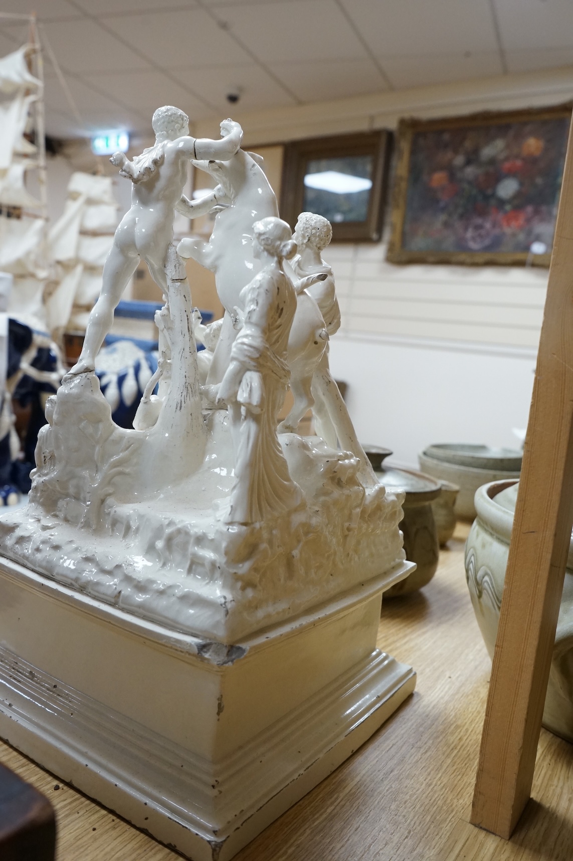 A 19th century Naples tin glazed pottery group of figures wrestling a Europa and the bull, 14in.